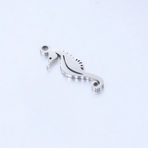 Detailed macro view of silver stainless steel seahorse pendant with polished finish