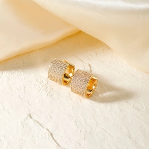 Elegant gold-plated wide hoop earrings with micro-paved zircons on a stone base