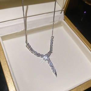 Close-up of sparkling zircon snake pendant on fine silver chain in premium jewelry box
