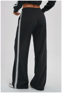 Detail view of the back showing black joggers with classic three white stripes on sides