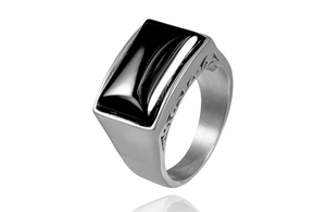 Macro detail of men's silver stainless steel ring featuring a rectangular black zircon stone