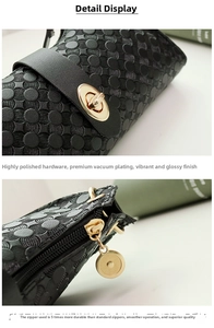Detailed macro view of black embossed leather bag with polished gold-tone metal lock