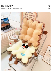 Close-up of biscuit-shaped cushion set with cartoon embroidery on a modern chair