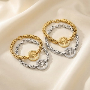 Golden and silver Tree of Life charm bracelets with sparkling crystals on silk fabric