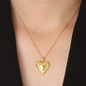 18k gold plated heart pendant necklace with textured sequins on female model neck