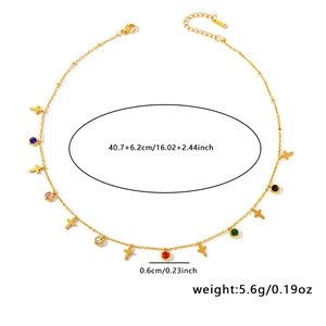 Detail of gold titanium steel necklace featuring multi-colored zircons and tiny crosses