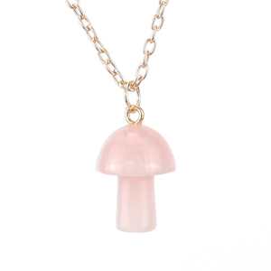 Macro shot of pink crystal mushroom pendant necklace with fine gold metal chain links