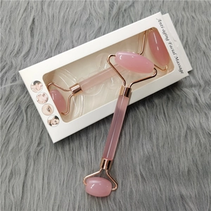 Pink quartz facial roller set in rose gold frame with anti-aging massage packaging
