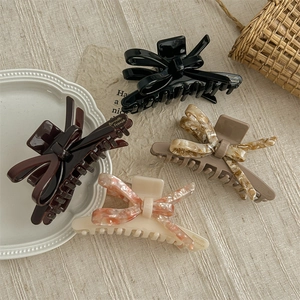 Set of four sweet acetate bow hair claws in black, brown, and marble textures