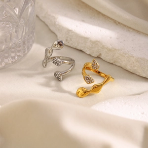 Detail of 18K gold and silver plated irregular wavy rings with pave micro diamonds