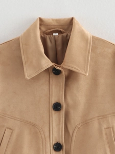 Macro view of tan suede jacket featuring a classic collar and large black buttons