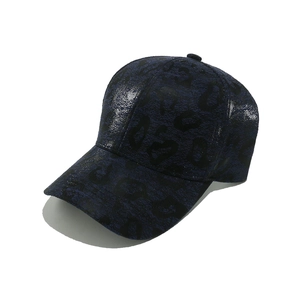 Detailed view of dark blue leopard print baseball cap with metallic coating and crackle texture