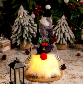Close-up of a Christmas gnome with glowing LED beard and reindeer antlers on a rustic base