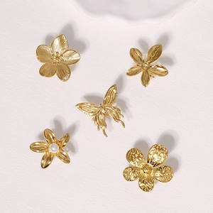 Detailed view of 5-piece gold stainless steel butterfly and pearl flower jewelry set