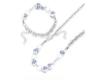 Detail of blue and white porcelain beads and silver metal chain jewelry set