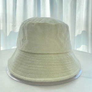 Close-up of white terry cloth bucket hat showing high-quality fuzzy loop fabric texture