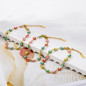 Detailed view of three gold evil eye bracelets featuring multi-colored enamel beads