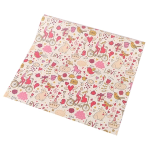 Close-up of wrapping paper with romantic cartoon illustrations and LOVE text patterns