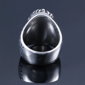 Detailed macro view of vintage stainless steel ring with engraved lettering on side