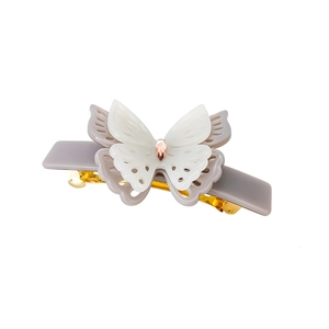 Detail of layered gradient butterfly hair claw clip with pink gemstone in gold setting