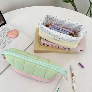 Detailed view of quilted cotton pencil cases with a soft star pattern lining and zippers