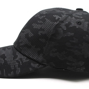 Close-up of charcoal baseball cap showing textured camouflage fabric and breathable eyelets
