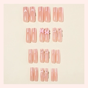 Extra long French tip press-on nails with pink bows, pearls and heart crystals