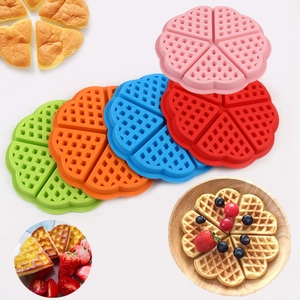 Macro shot of flower-shaped silicone waffle molds in vibrant pink, blue, red and orange