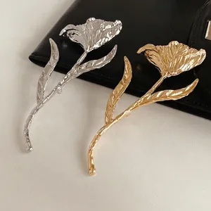 Elegant tulip flower brooch in gold and silver finish with embossed metal texture