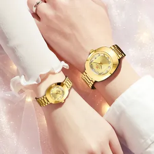 Close-up of golden couple watches with diamond accents on metal bands worn by a couple