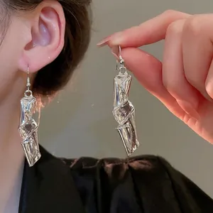 Irregular silver textured drop earrings with crumpled metal design for a modern look