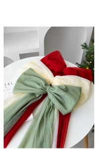Detail of oversized mesh bow decorations in red, white and green for Christmas trees