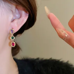 Three-color oval gemstone drop earrings with purple green and red stones in gold setting