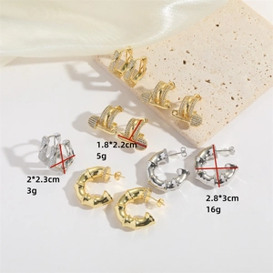 Collection of luxury C-shaped stud earrings and textured hoop earrings in gold and silver