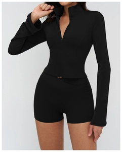 Detail of black sports set with slim fit zip jacket and high-waist athletic shorts