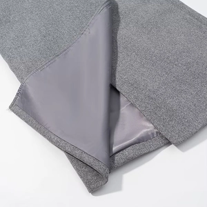 Detailed macro view of the grey wool coat's inner lining and high-quality stitching seams