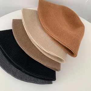Five assorted colors of cozy ribbed knit beanies for women in a fan-shaped flat lay display