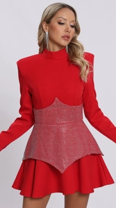 Close-up of red long-sleeved dress featuring shimmering silver rhinestone waist detail