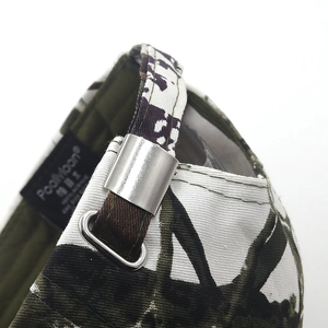 Detailed close-up of cow print baseball cap with adjustable silver metal buckle