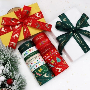 Detail of Christmas ribbons with festive elk and tree patterns for gift box wrapping