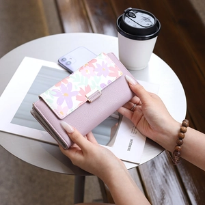 Close-up of lilac floral print PU leather long wallet with elegant metal clasp detail