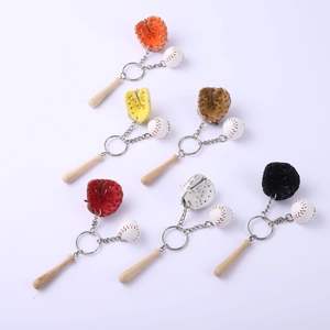 Flat lay detail of baseball keychain sets featuring glove, ball, and wooden bat charms