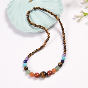 Macro view of colorful 6mm natural crystal gemstone beads with tiger eye stones necklace
