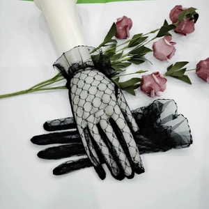 Detail of black lace mesh gloves with floral patterns and ruffled cuffs for parties