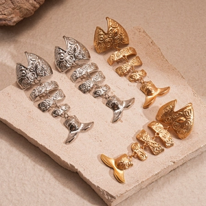 Dramatic metallic fishbone earrings in gold and silver finish with detailed relief patterns
