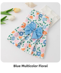 Detail of floral pet dress showing light fabric, orange flower prints and big blue bow