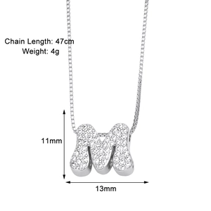 Detail view of the silver 'M' initial pendant with cubic zirconia on a 47cm chain