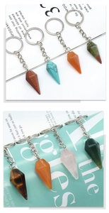Macro shot of assorted natural crystal conical keychains in tiger eye and rose quartz stones