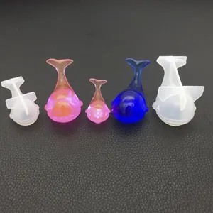 Detailed view of DIY whale silicone molds and finished resin art in various colors