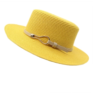 Detail of yellow straw sun hat featuring a beige PU leather band and gold buckle
